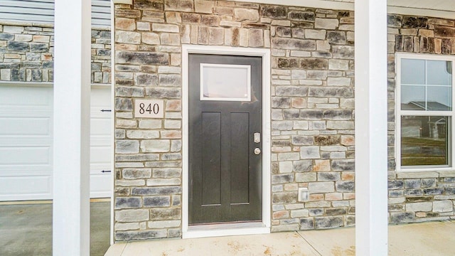 doorway to property featuring stone siding