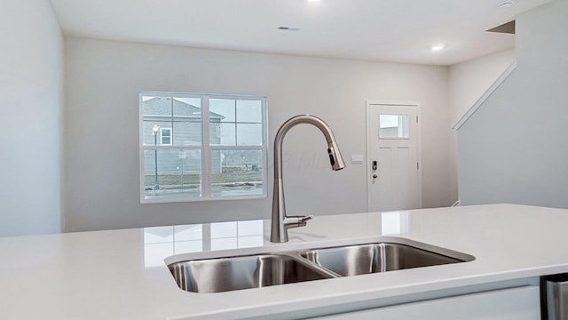 kitchen featuring recessed lighting, a wealth of natural light, a sink, and light countertops