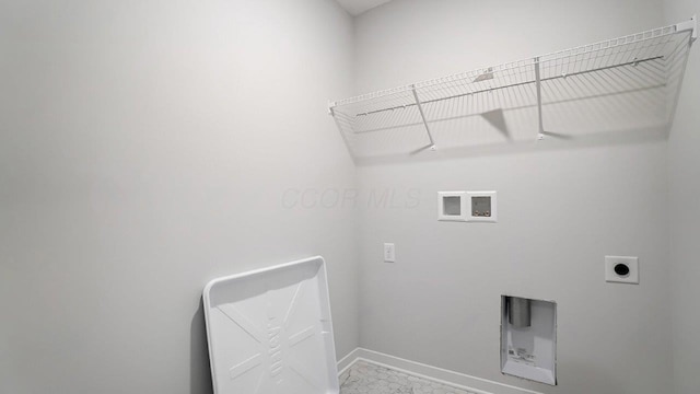 laundry area with baseboards, hookup for an electric dryer, washer hookup, and laundry area