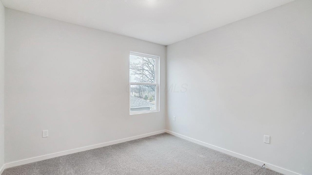 unfurnished room featuring baseboards and carpet floors