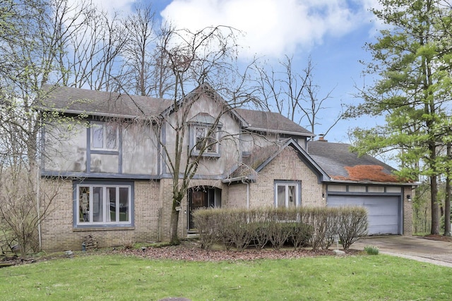 view of front of property featuring an attached garage, concrete driveway, a front yard, and brick siding