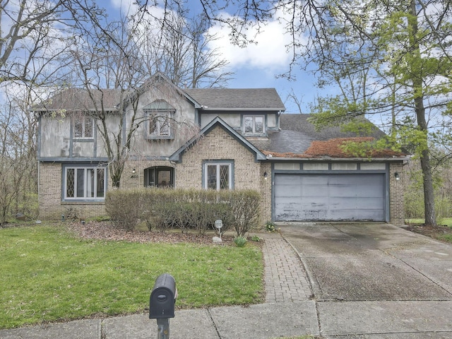 tudor home featuring brick siding, an attached garage, and driveway