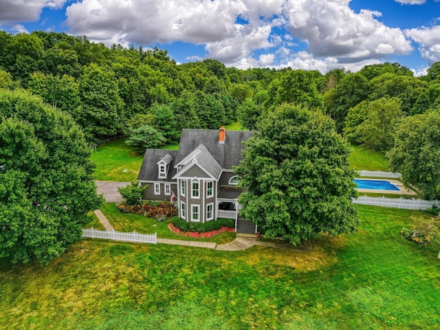 drone / aerial view with a wooded view