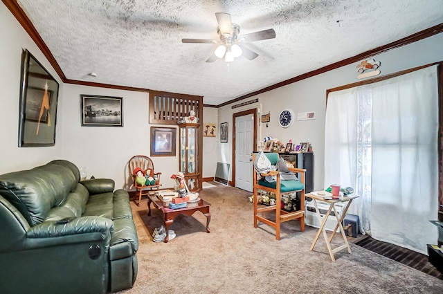 living area with a textured ceiling, a ceiling fan, crown molding, and carpet floors