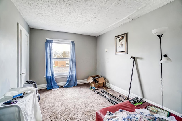 bedroom featuring a textured ceiling, carpet flooring, and baseboards