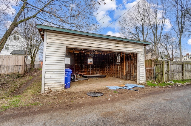 detached garage featuring fence