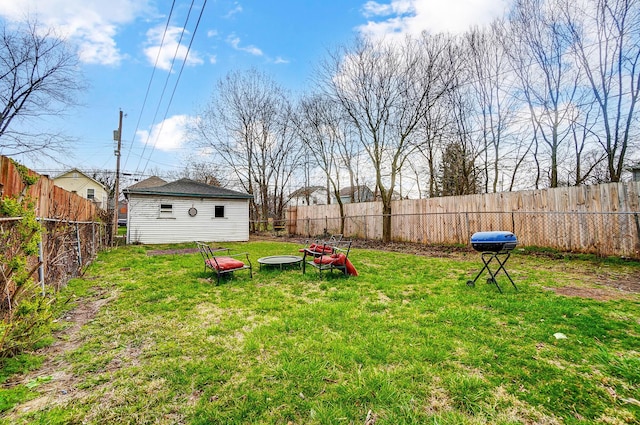 view of yard with a fenced backyard and an outdoor structure