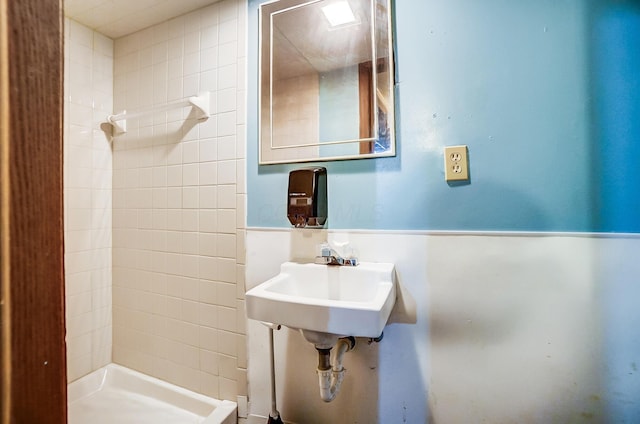 bathroom featuring a shower stall and a sink