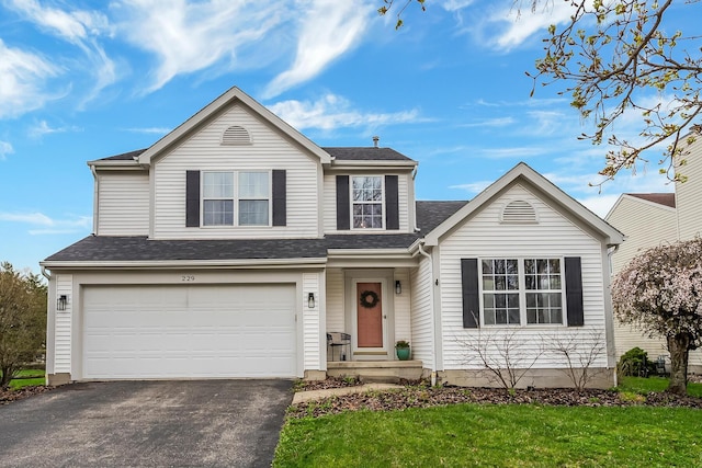 traditional home featuring a front lawn, a garage, driveway, and roof with shingles