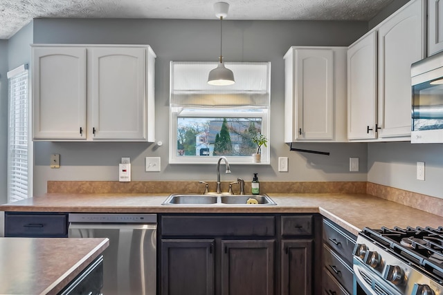 kitchen featuring a sink, light countertops, white cabinets, and appliances with stainless steel finishes