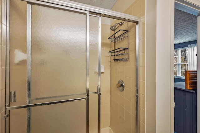 full bathroom with a shower stall and a textured ceiling