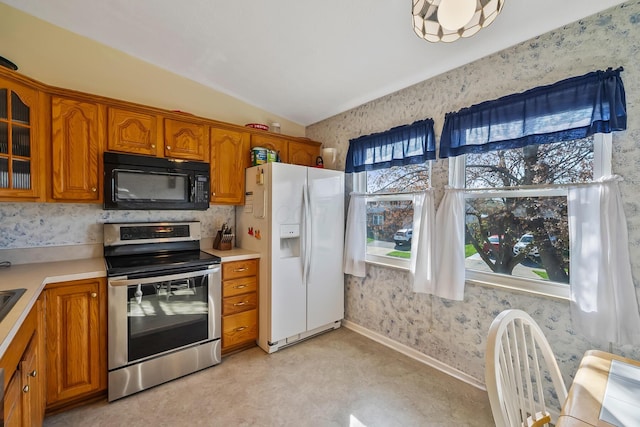 3588 Silverado Dr, Columbus, OH 43228 - kitchen with white refrigerator with ice dispenser, a healthy amount of sunlight, stainless steel range with electric cooktop, and black microwave