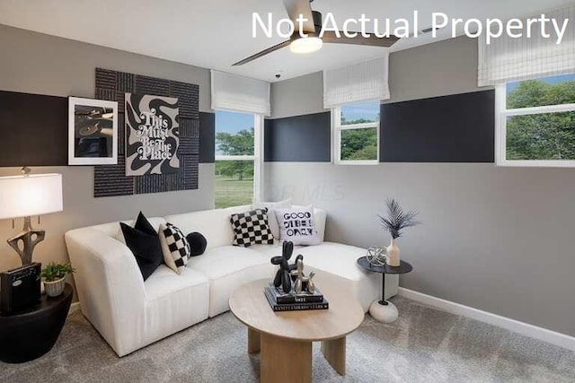 carpeted living room featuring baseboards and ceiling fan