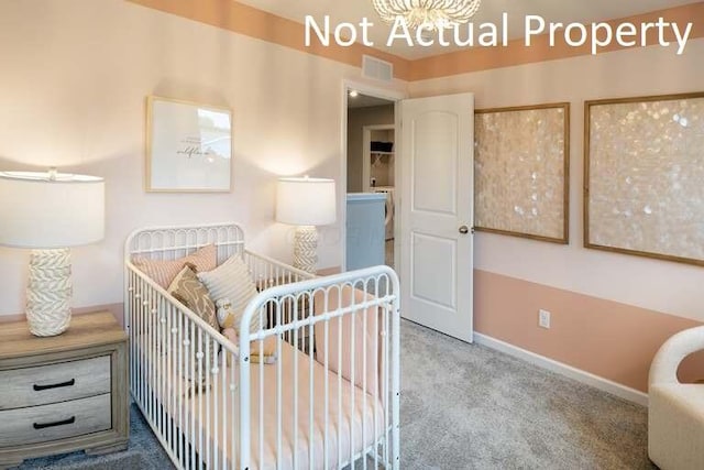 bedroom featuring baseboards, visible vents, carpet floors, and a chandelier