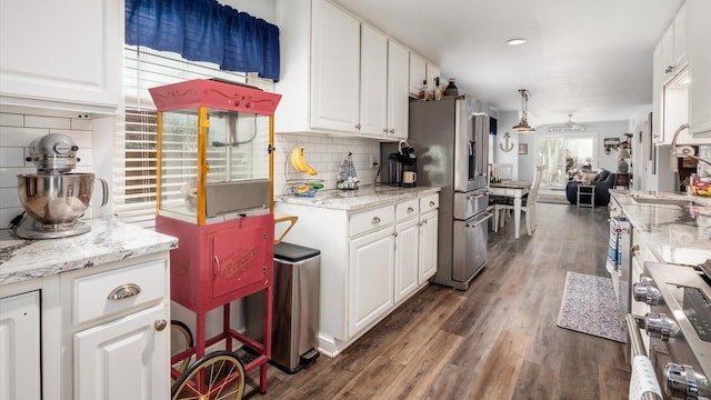 kitchen with dark wood-style flooring, white cabinets, and appliances with stainless steel finishes