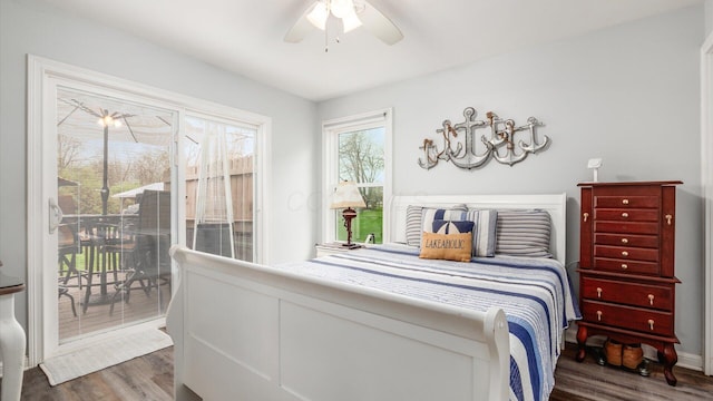 bedroom featuring a ceiling fan, access to outside, and wood finished floors