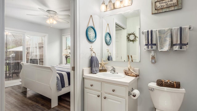 ensuite bathroom featuring vanity, toilet, a ceiling fan, ensuite bathroom, and wood finished floors
