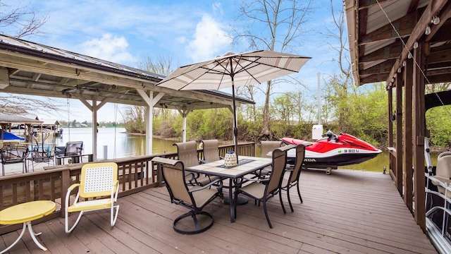 wooden deck featuring boat lift, a water view, and a boat dock