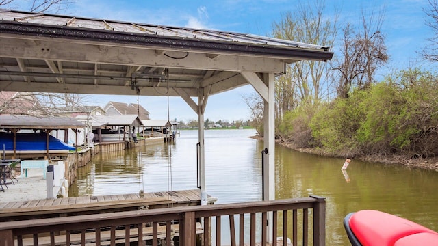 dock area with boat lift and a water view