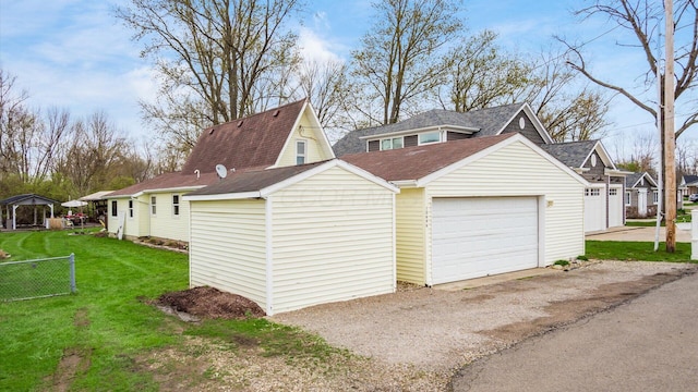 garage with driveway and fence