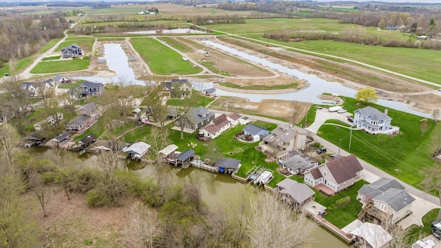 birds eye view of property with a residential view and a water view