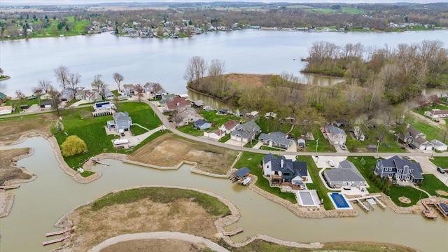 birds eye view of property with a water view and a residential view