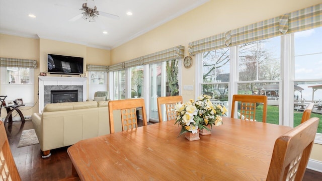 40 Beacon Light Ln, Buckeye Lake, OH 43008 - dining area featuring dark wood finished floors, ornamental molding, a high end fireplace, and a ceiling fan