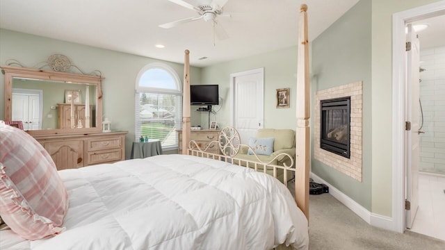 40 Beacon Light Ln, Buckeye Lake, OH 43008 - carpeted bedroom featuring baseboards, a ceiling fan, connected bathroom, and a fireplace