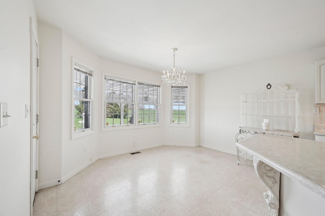 unfurnished dining area with visible vents, baseboards, a notable chandelier, and light floors