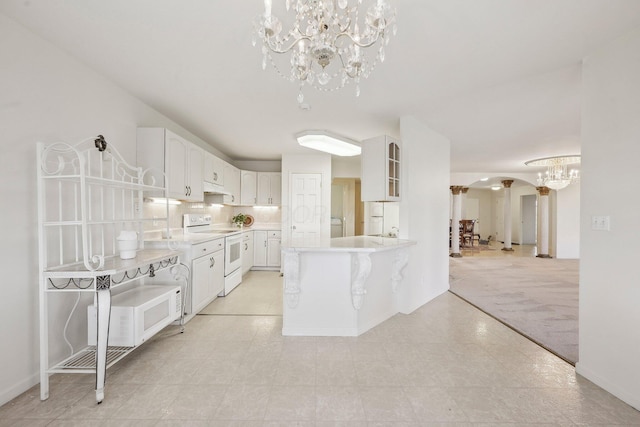 kitchen with white cabinets, light countertops, white electric stove, and an inviting chandelier