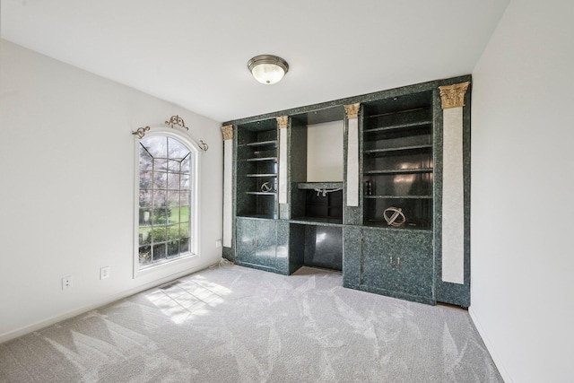 interior space featuring baseboards and carpet flooring