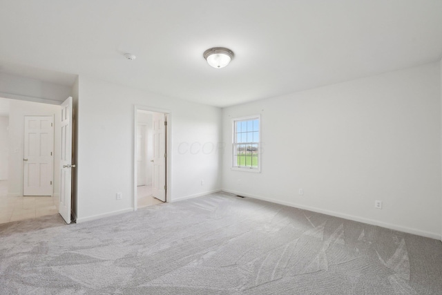 unfurnished bedroom featuring visible vents, baseboards, and carpet floors