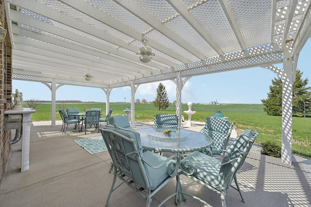 view of patio / terrace with a rural view, outdoor dining space, a pergola, and a ceiling fan