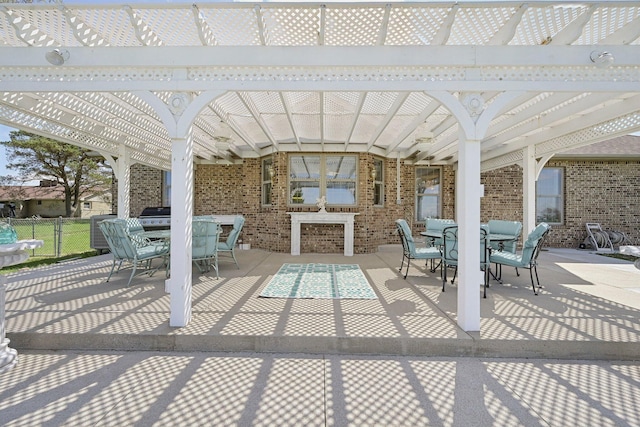 view of patio with outdoor dining space, a pergola, and fence