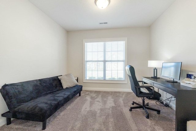 office space featuring carpet floors, baseboards, and visible vents