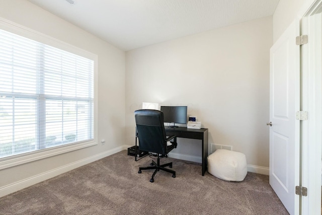 office with carpet flooring, visible vents, and baseboards