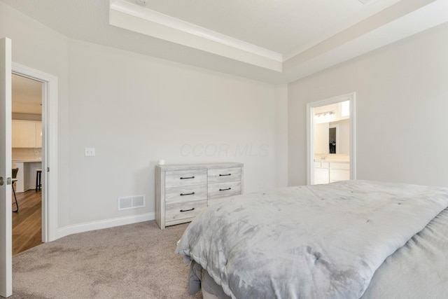 bedroom with a raised ceiling, light colored carpet, baseboards, and visible vents