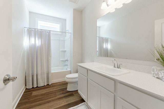 bathroom with shower / bath combo, toilet, vanity, and wood finished floors