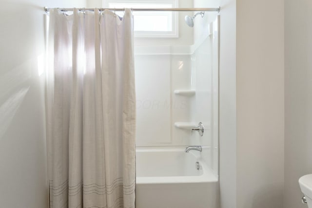 bathroom featuring toilet and shower / bathtub combination with curtain