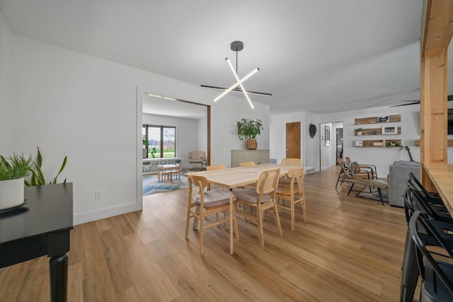 dining room with baseboards and light wood-type flooring