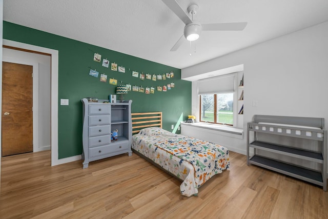 bedroom with wood finished floors, ceiling fan, and baseboards