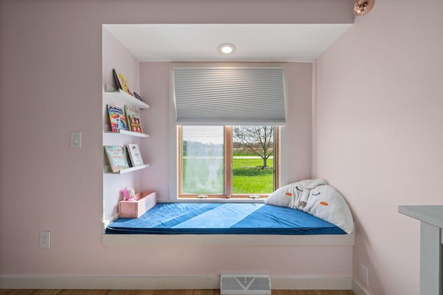 bedroom featuring baseboards and visible vents