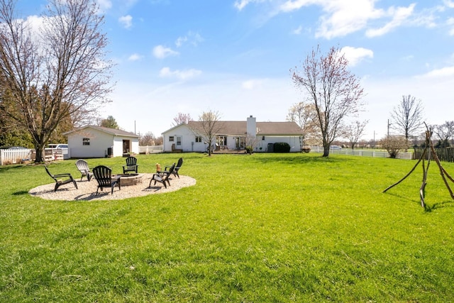 view of yard with an outdoor fire pit and fence