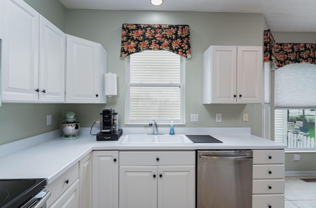 4497 Battles St, New Albany, OH 43054 - kitchen with stainless steel dishwasher, a sink, white cabinetry, and healthy amount of natural light