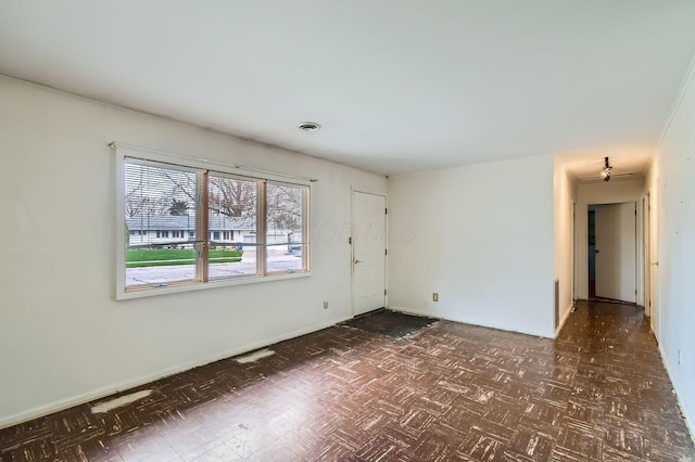 empty room with dark floors and visible vents