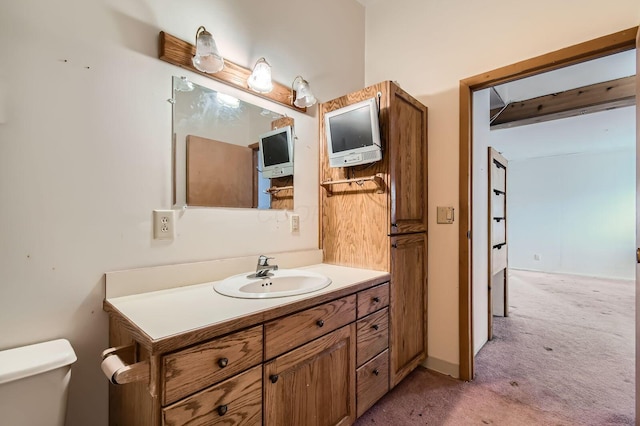 bathroom featuring vanity and toilet