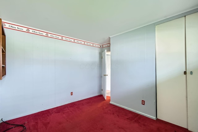 unfurnished bedroom featuring carpet and a closet