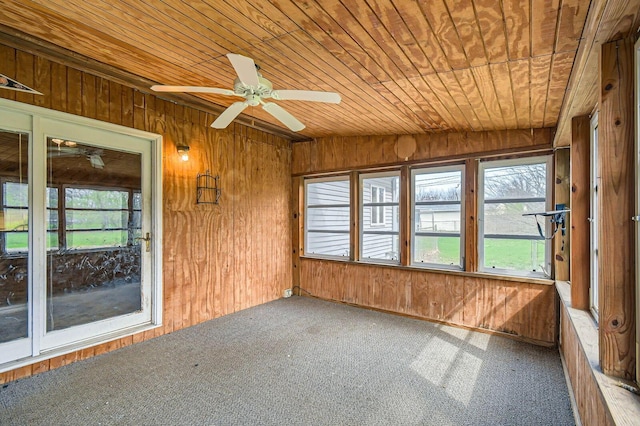 unfurnished sunroom featuring a ceiling fan