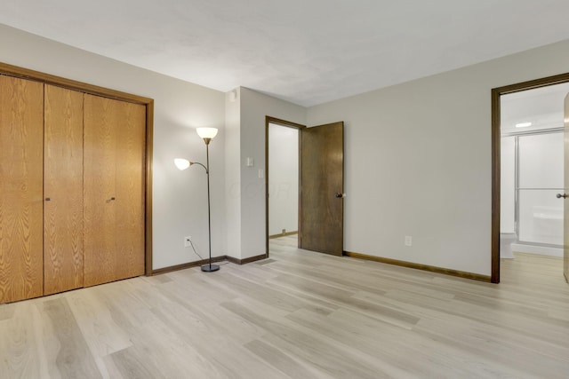 8015 Alspach Rd NW, Lancaster, OH 43130 - unfurnished bedroom with light wood-style flooring, a closet, baseboards, and ensuite bath