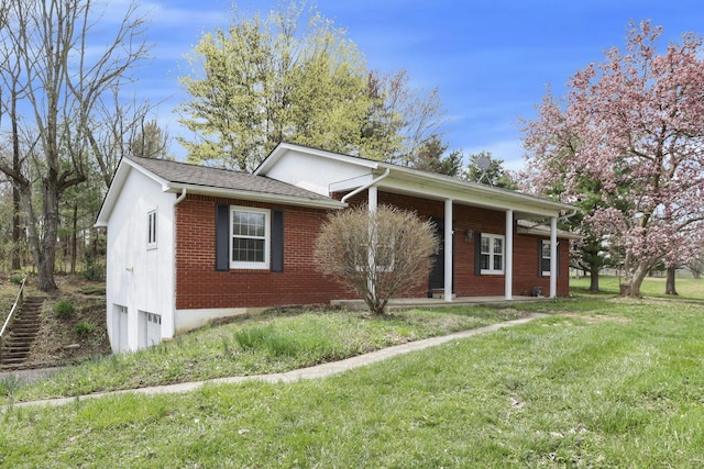 8015 Alspach Rd NW, Lancaster, OH 43130 - view of front facade featuring an attached garage, brick siding, a front yard, and covered porch